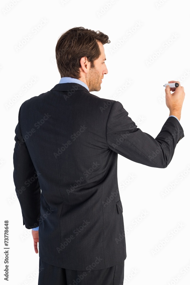 Businessman standing back to camera writing with marker Businessman standing back to camera writing with marker