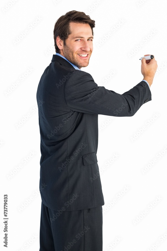 Businessman writing with marker while looking at camera Businessman writing with marker while looking at camera