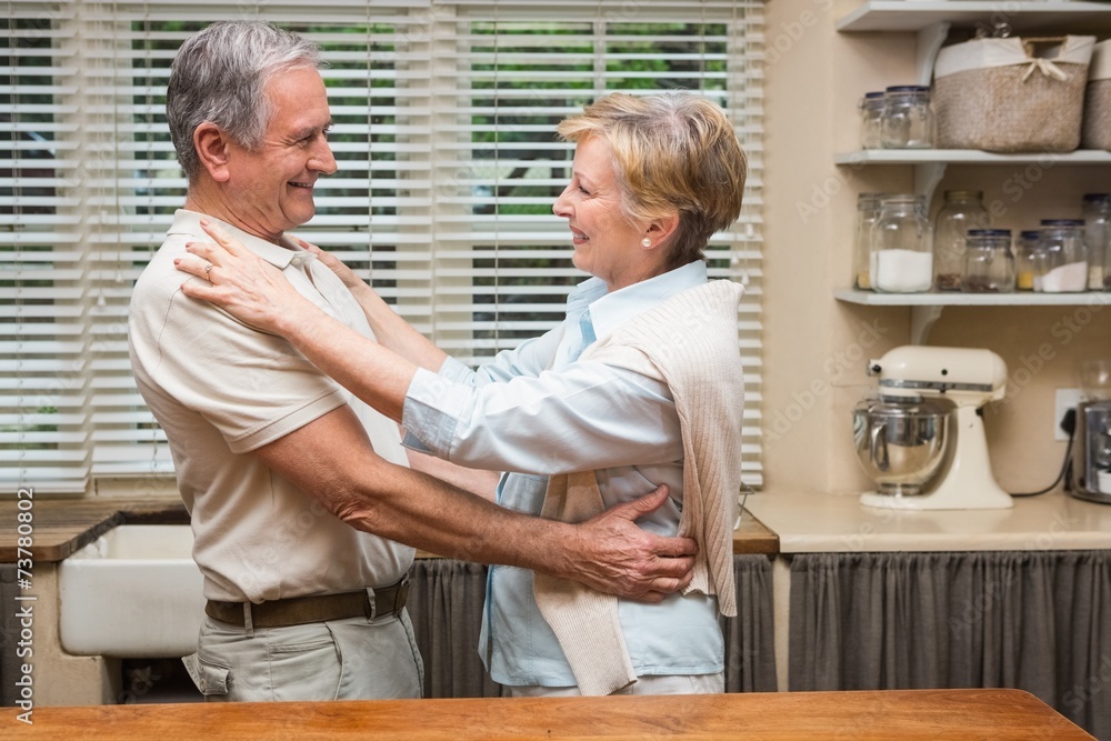 Obraz premium Senior couple hugging and smiling