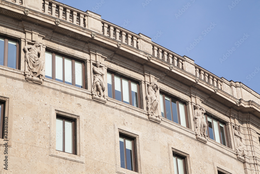 Antique facade with sculptures and blue sky Antique facade with sculptures and blue sky