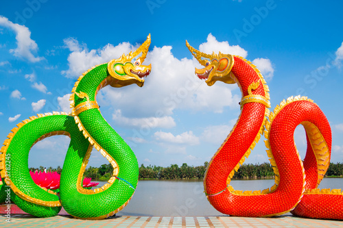 Thai dragon or Naga statue with blue sky background at Thailand