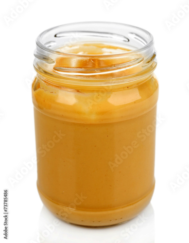 Creamy peanut butter in jar, isolated on white