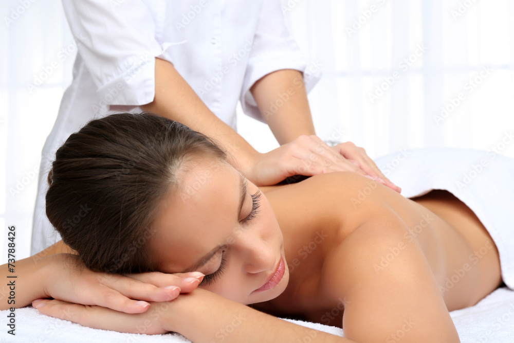 Masseur doing massage on woman body isolated on white. Masseur doing massage on woman body isolated on white.