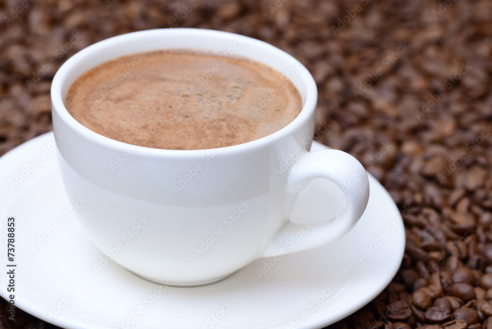 cup of coffee on a coffee beans background cup of coffee on a coffee beans background