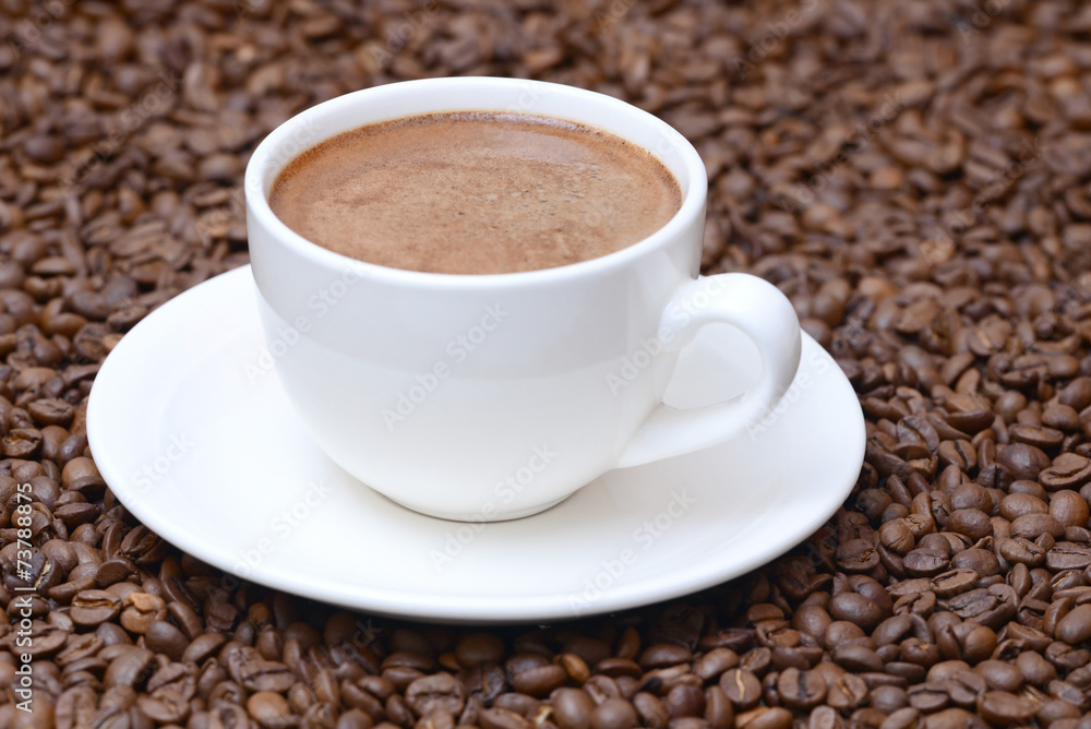 cup of coffee on a coffee beans background cup of coffee on a coffee beans background