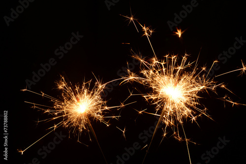 Two burning christmas sparklers