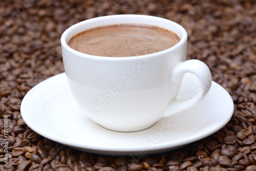 cup of coffee on a coffee beans background