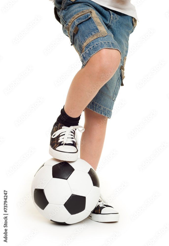 Fototapeta premium feet shod in sneakers and soccer ball