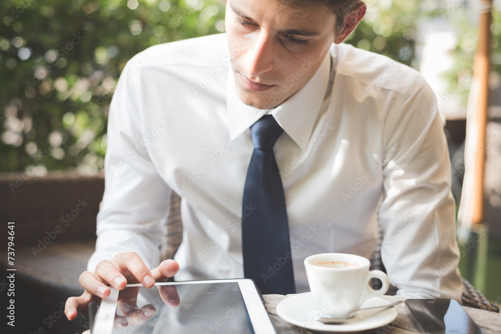 young handsome elegant blonde model businessman working with tab young handsome elegant blonde model businessman working with tab