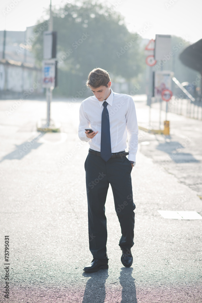 young handsome elegant blonde model man using smart phone young handsome elegant blonde model man using smart phone