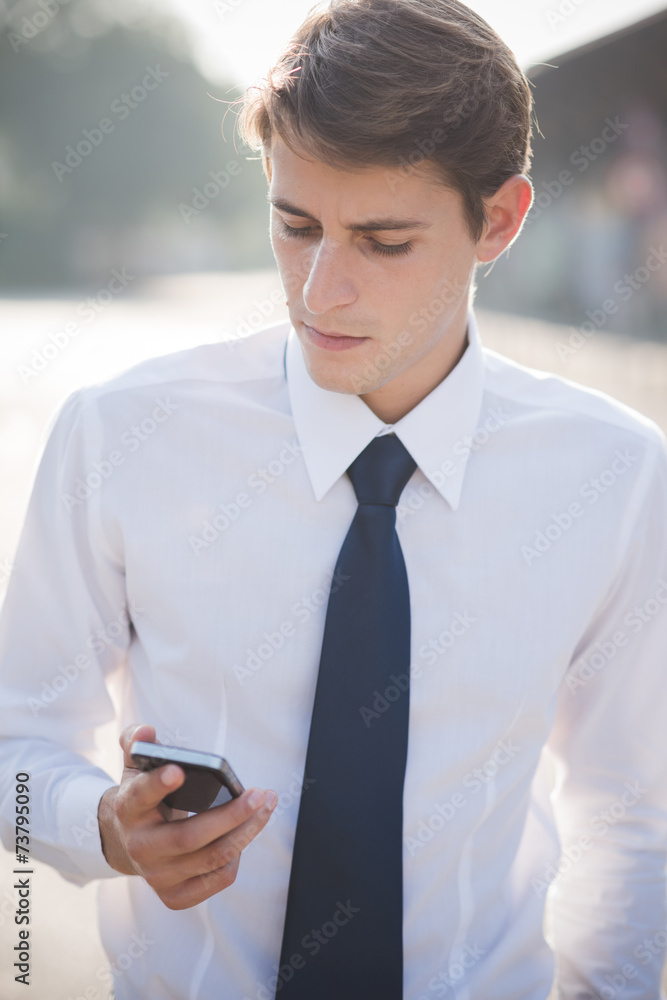 young handsome elegant blonde model man using smart phone young handsome elegant blonde model man using smart phone