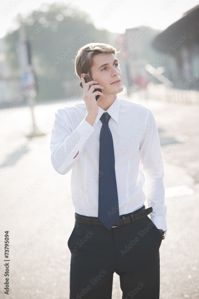 young handsome elegant blonde model man using smart phone young handsome elegant blonde model man using smart phone