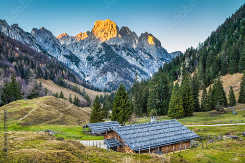 Mountain landscape in the Alps with chalets at sunset