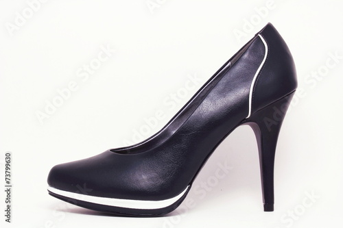 Black elegant shoe with white stripes.