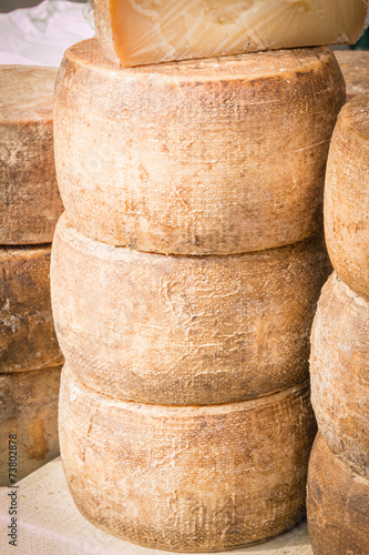 stacked rounded cheese for sale in market