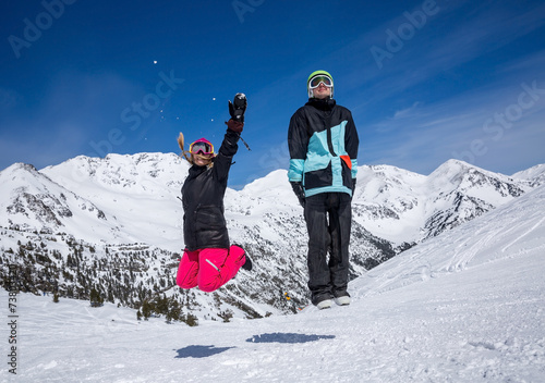 Happy couple jumping in mountains photo