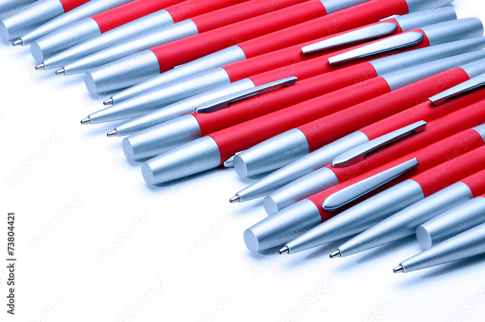 Silver-red metal pens isolated on white background.