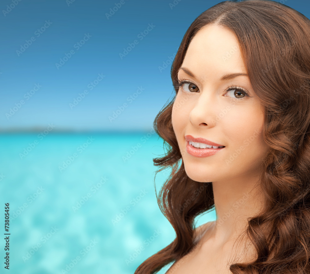 beautiful young woman over blue sky and sea