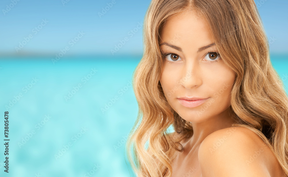 beautiful young woman over blue sky and sea
