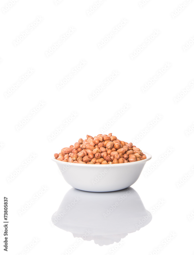 Peanut or ground nut in white bowl over white background Peanut or ground nut in white bowl over white background