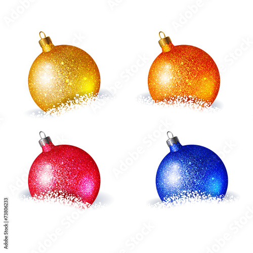 Set of bright colored Christmas balls, which lie in the snow