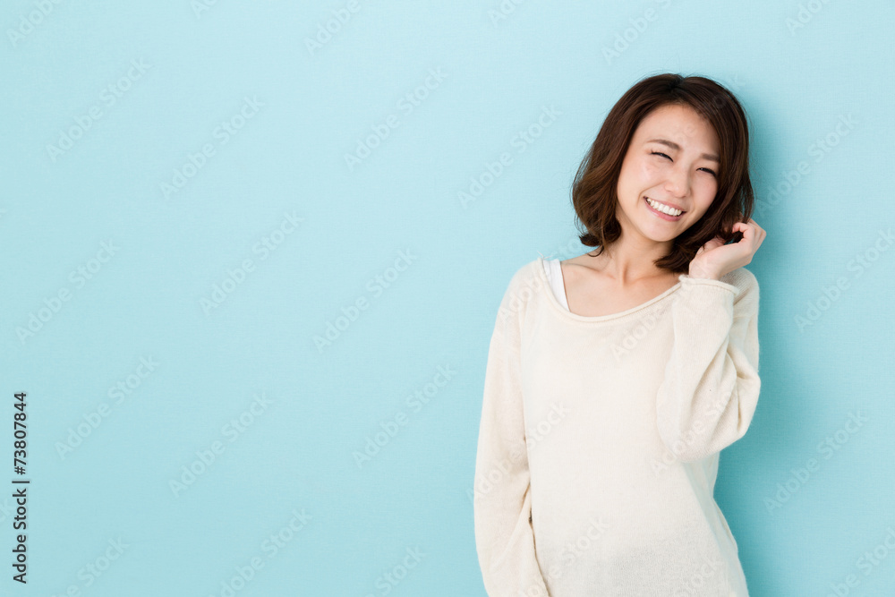 attractive asian woman on blue background attractive asian woman on blue background