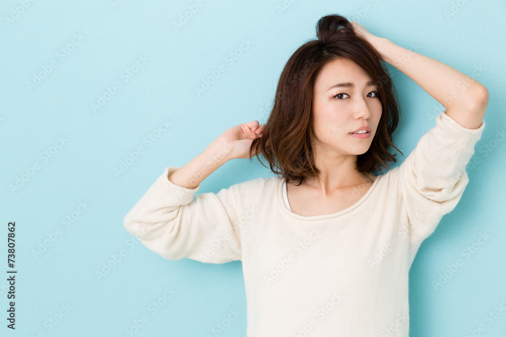 Fototapeta premium attractive asian woman on blue background