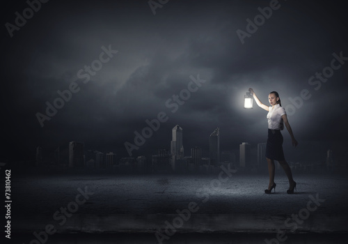 Businesswoman with lantern