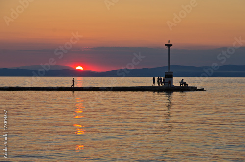 Lighthouse in Limenas harbour at sunset, island of Thassos photo