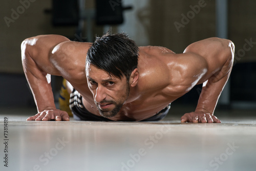 Young Man Doing Press Ups In Gym