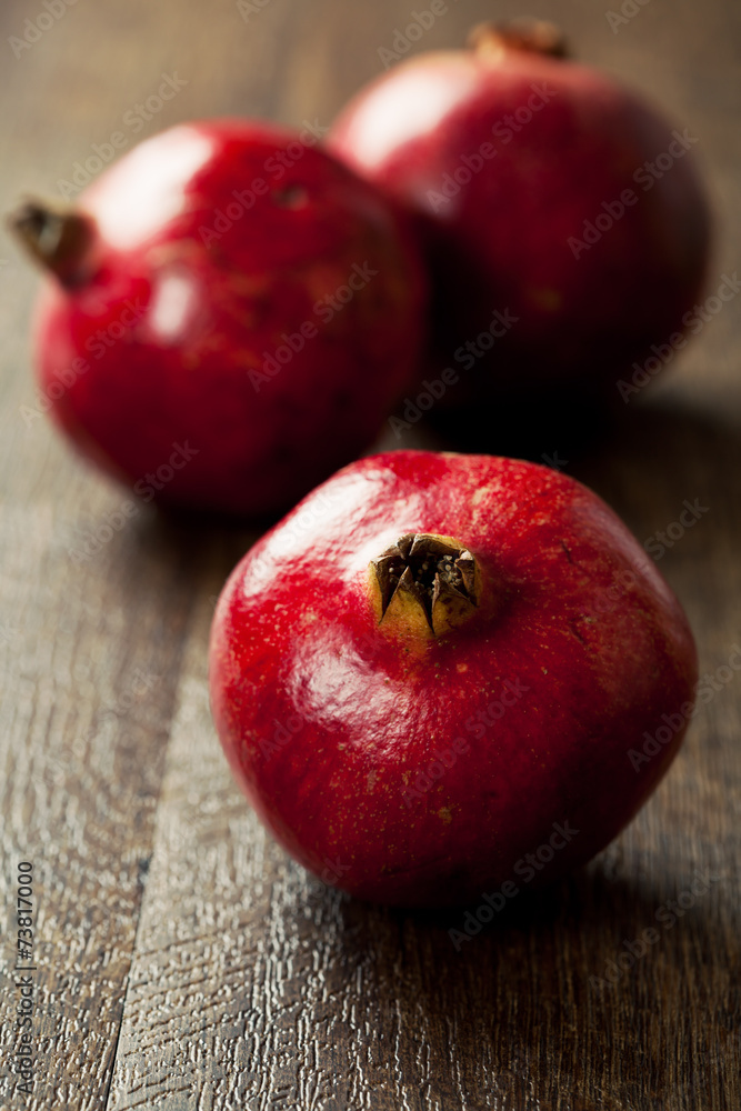 Fresh ripe pomegranates on wooden background Fresh ripe pomegranates on wooden background