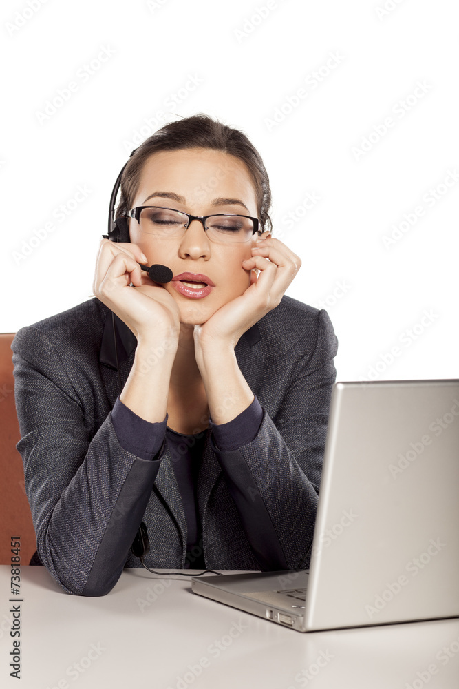The girl working in the call center and is sleepy and tired The girl working in the call center and is sleepy and tired