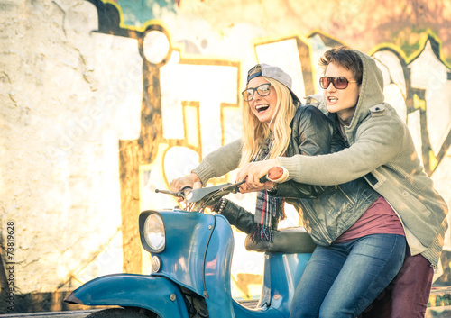 Foto Young couple in love haviing fun on a vintage scooter moped