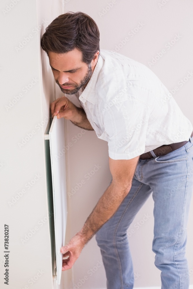 Handyman hanging up a radiator Handyman hanging up a radiator
