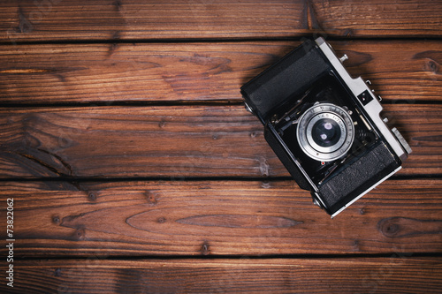 Vintage camera on wooden background