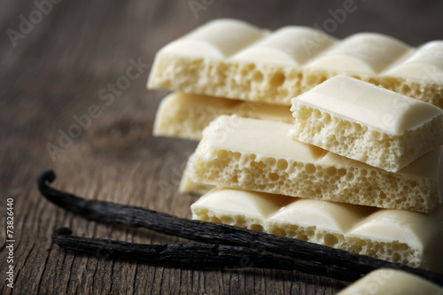 Tasty white porous chocolate with vanilla sticks