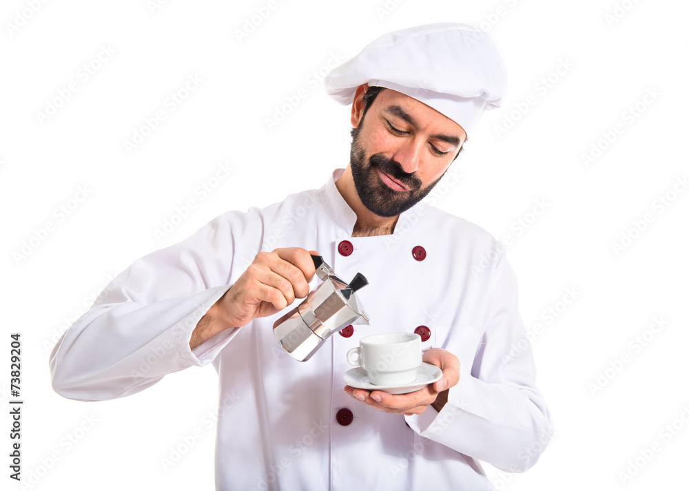 Chef holding a cup of coffee over white background Chef holding a cup of coffee over white background