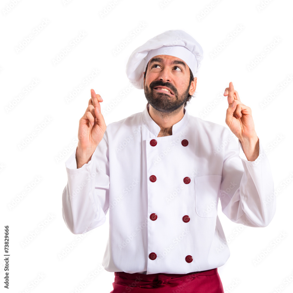 Chef with his fingers crossing over white background Chef with his fingers crossing over white background