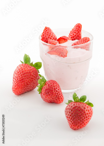 Fresh strawberry with yogurt in a glass isolated on white