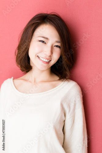 attractive asian woman on red background
