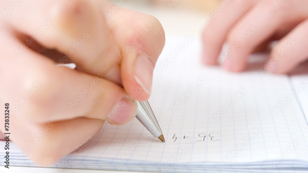 Child doing homework math closeup Child doing homework math closeup