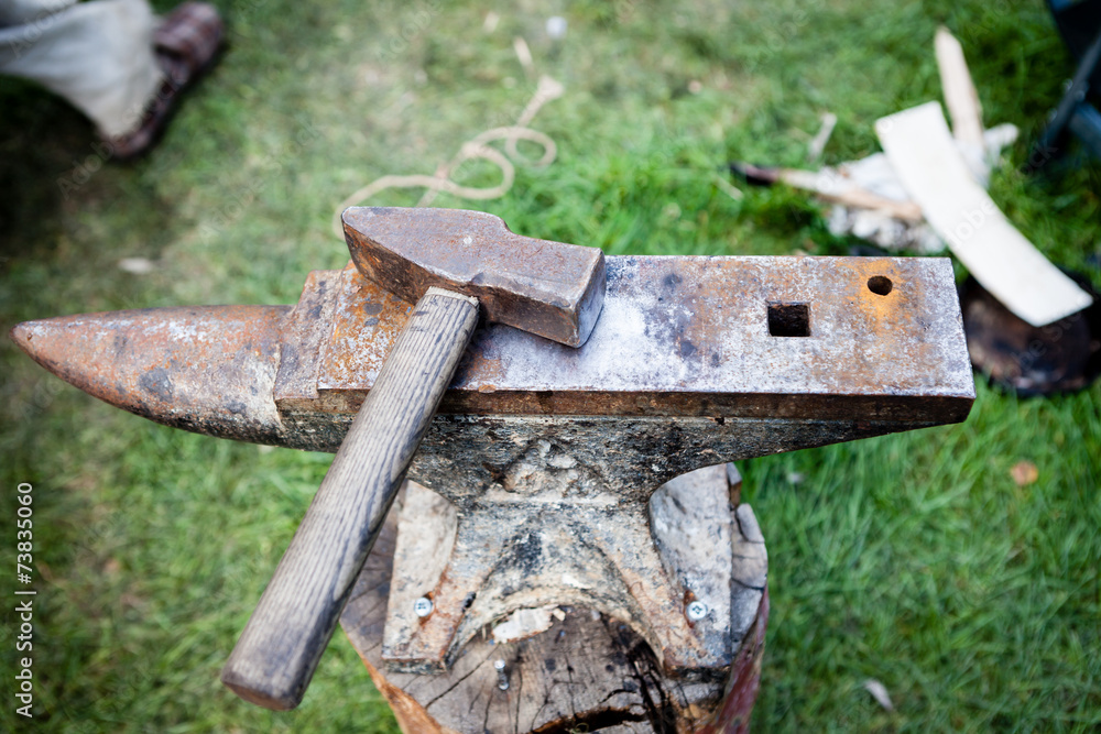 Rusty iron anvil and hammer Rusty iron anvil and hammer