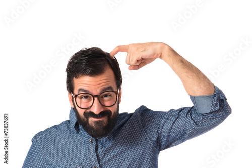 Young hipster man thinking over white background