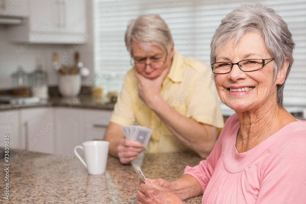 Senior couple playing cards at the counter