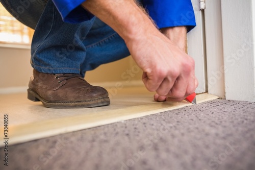 Принти на полотні Handyman laying down a carpet