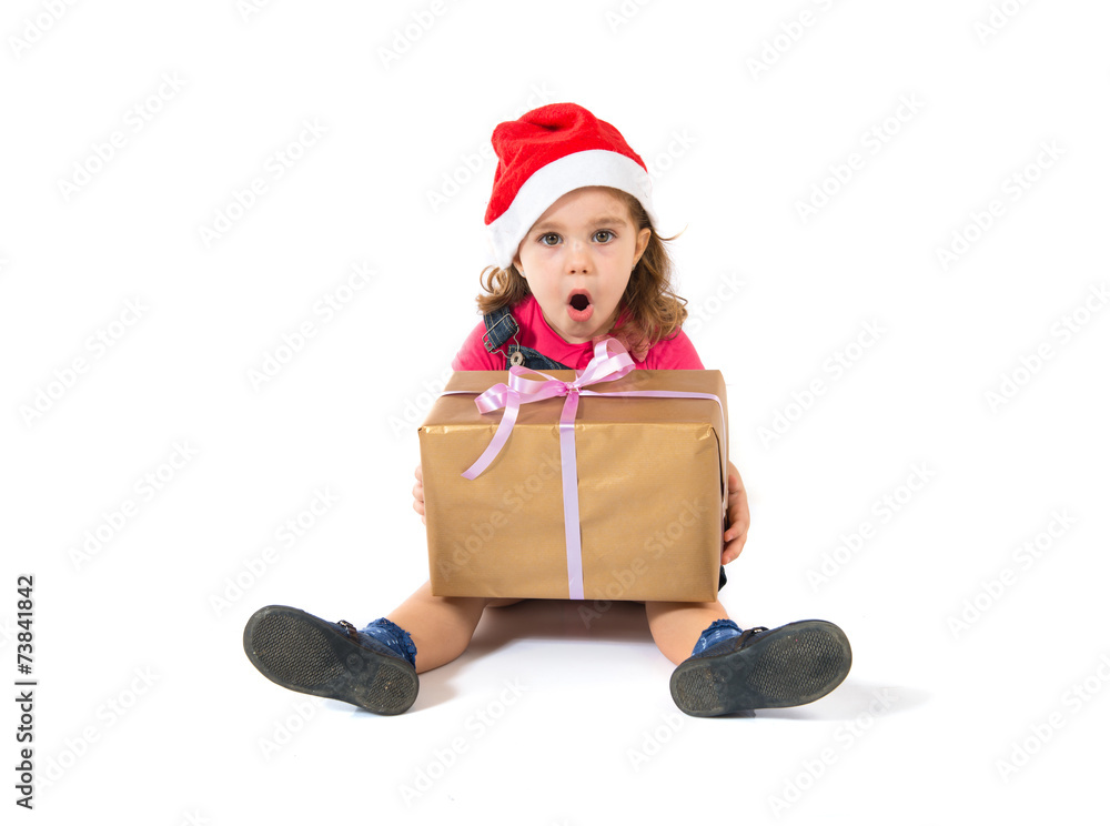 Surprised blonde christmas kid with present Surprised blonde christmas kid with present