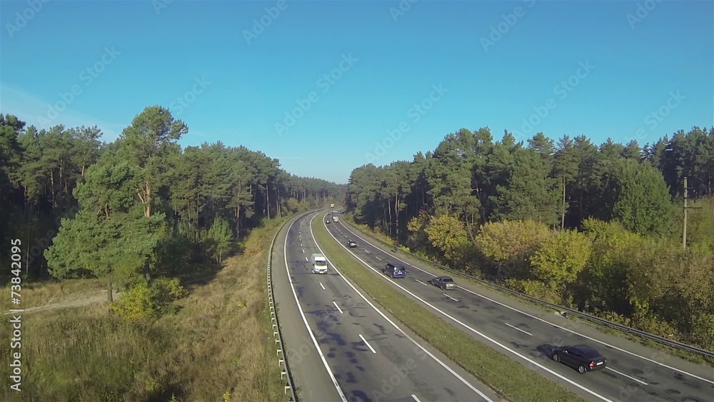 highway with cars in sunny day and wood. Aerial highway with cars in sunny day and wood. Aerial