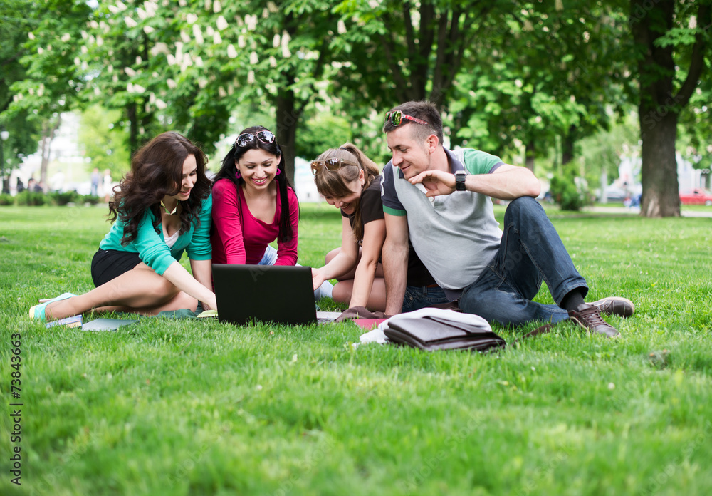 Group of young college students sitting on grass Group of young college students sitting on grass