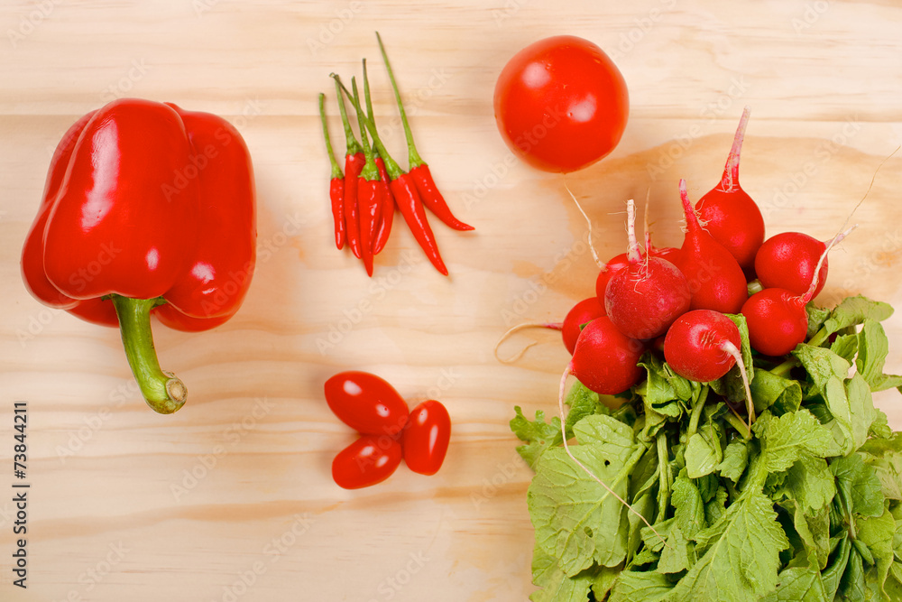 Red vegetables on a wooden background