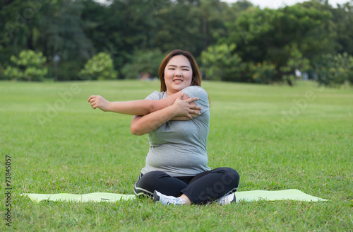 obese women yoga on grass